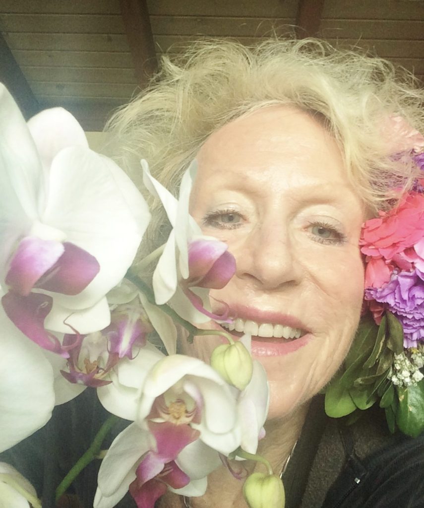 close photo of a woman and flowers