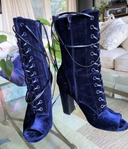 pair of blue velvet boots on a table